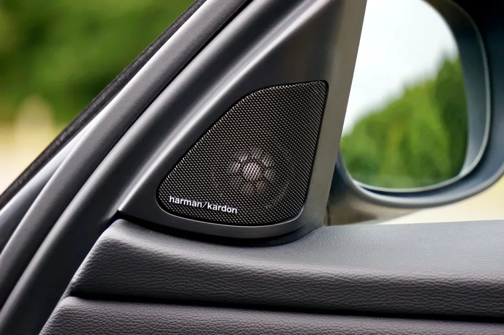 Tweeter mounted in the sail panel at the front corner of a car door