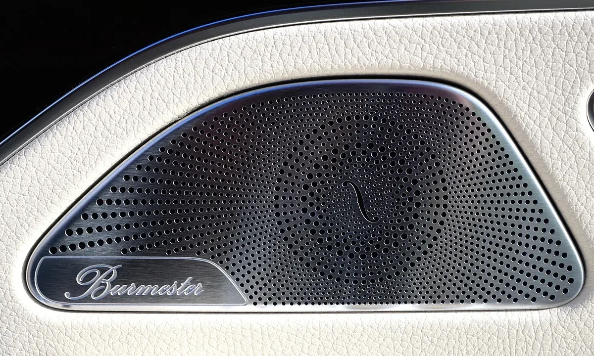 How to clean car speakers: close-up of a perforated metal speaker grille on a car door
