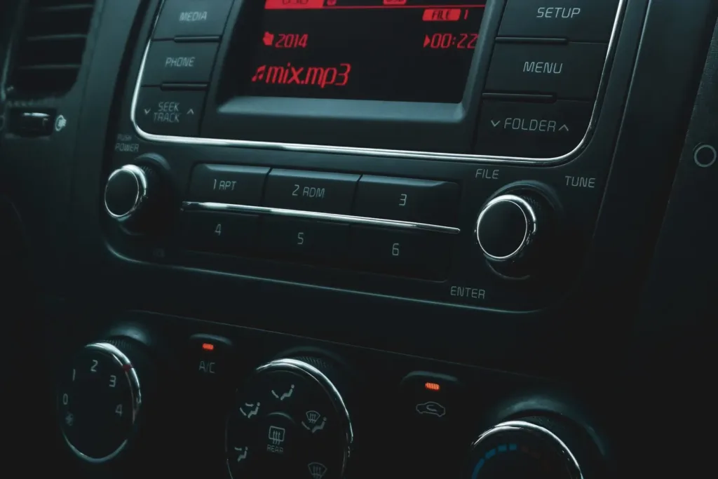 Car radio with a display and control buttons in the center dashboard
