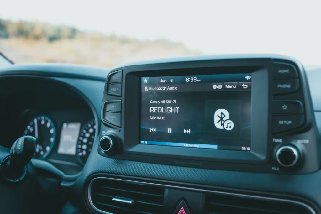Car stereo display playing Bluetooth audio in a dashboard