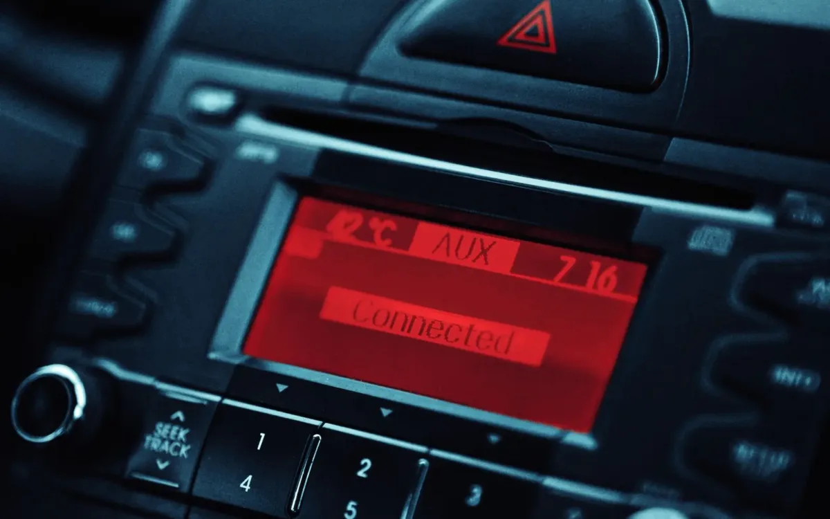 Car stereo with a red AUX display, a common starting point for how to fix car stereo problems