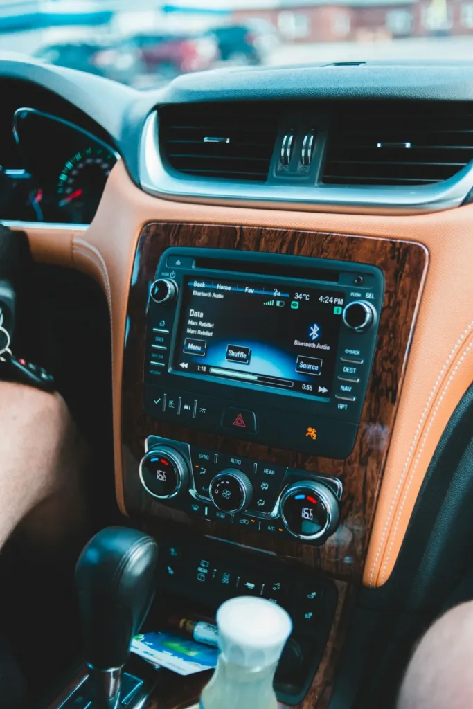 Touchscreen car stereo in a dashboard with wood-grain trim