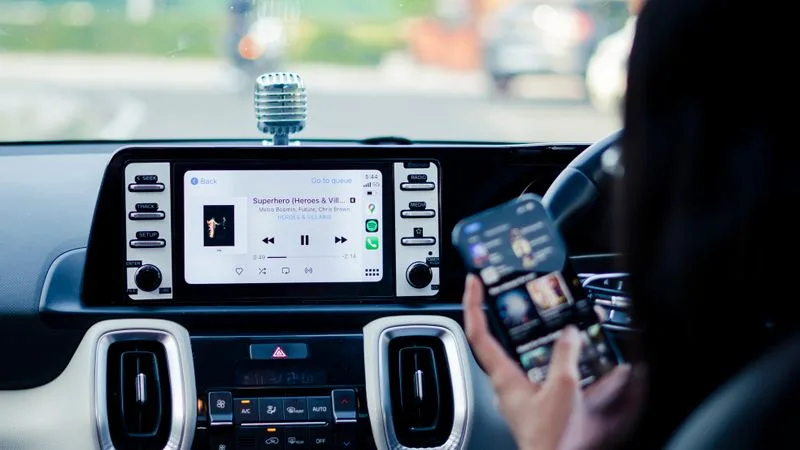 A double-DIN car head unit in a dashboard showing a touchscreen interface