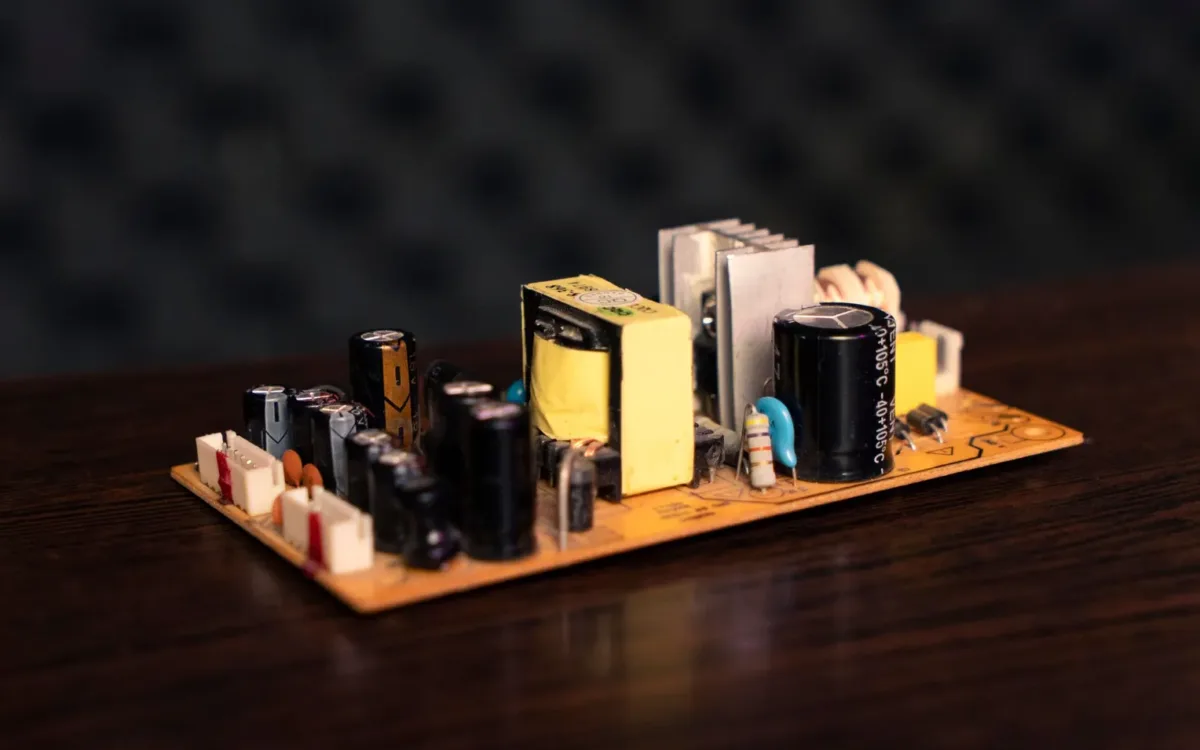 Circuit board with capacitors and coils explaining how does a crossover work for car audio