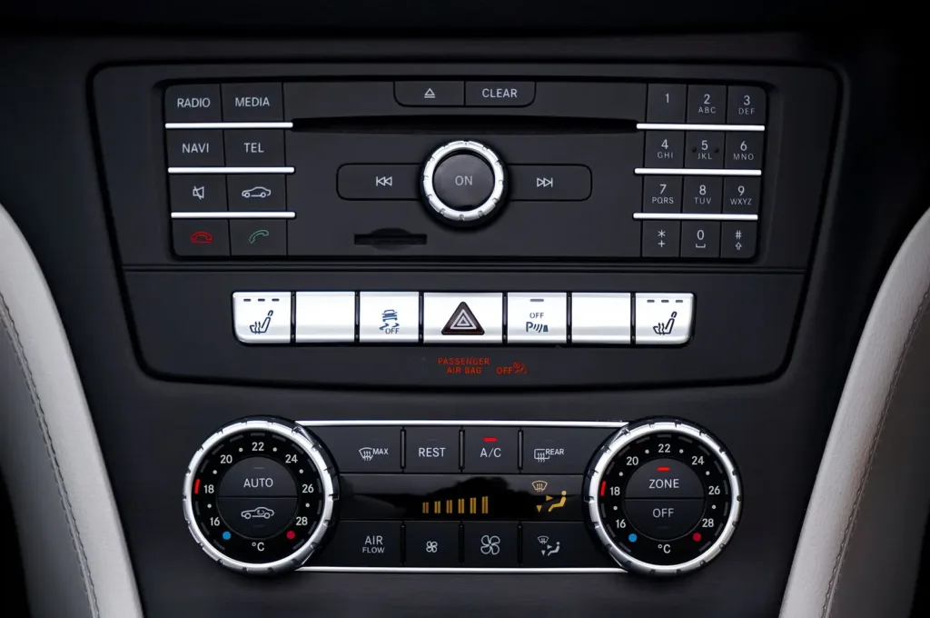 Dashboard media controls with a volume dial and audio buttons