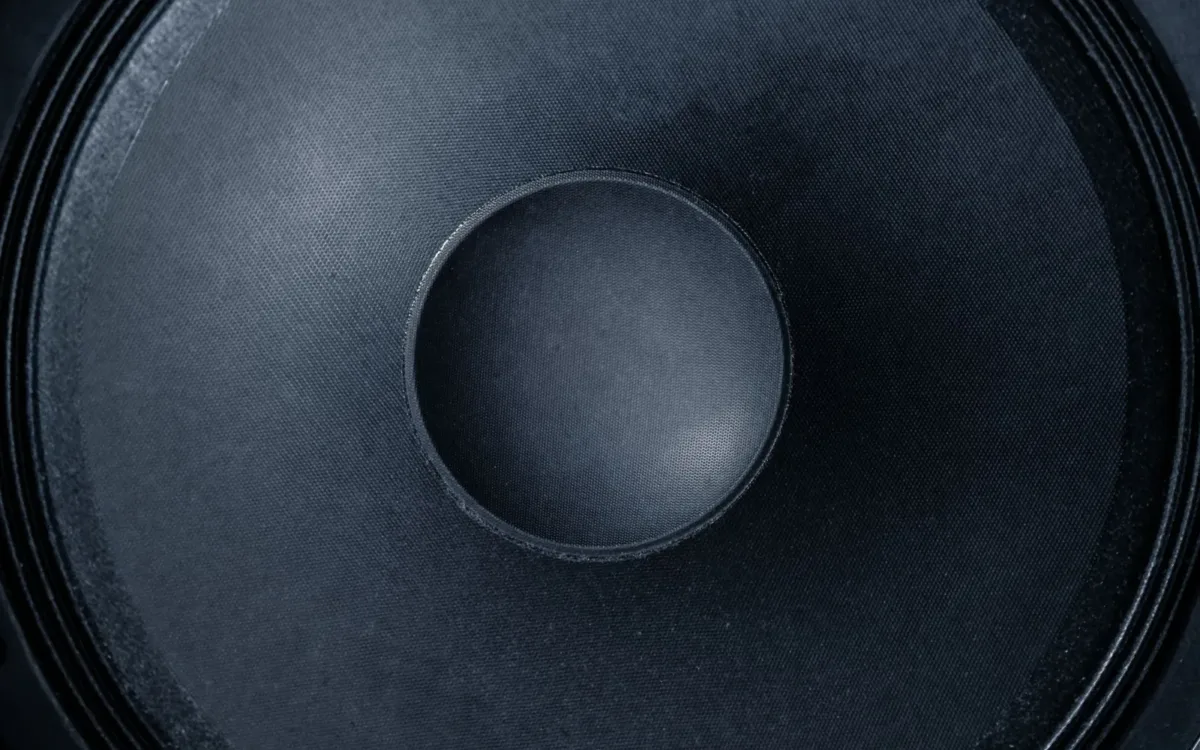 Close-up of a large subwoofer cone for a guide to the best amp for 15 inch subwoofer