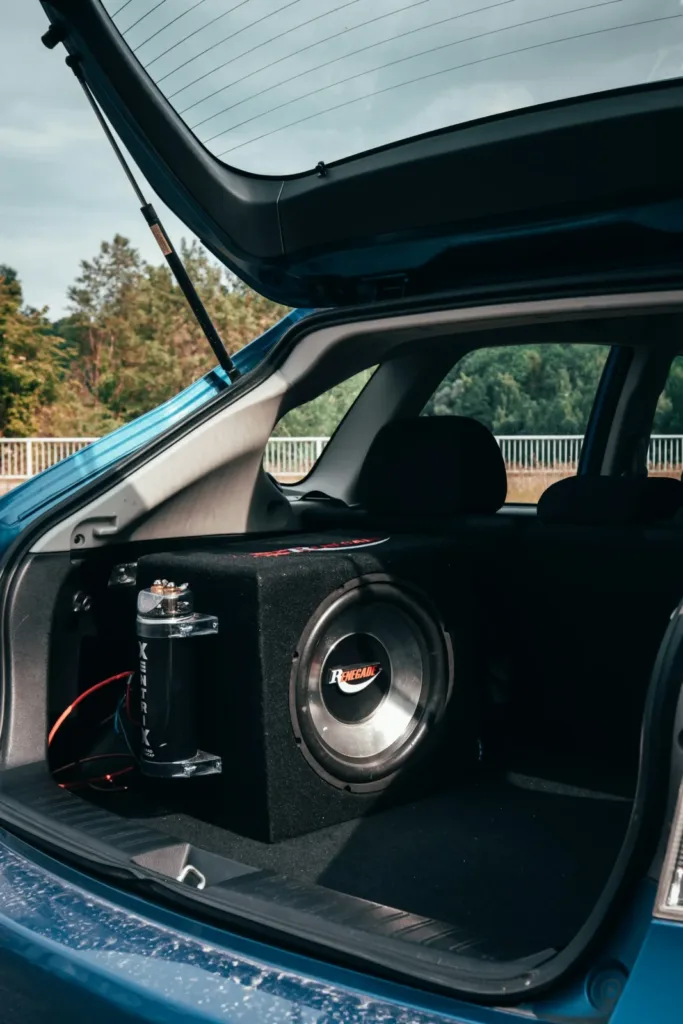 Subwoofer box sitting in the open trunk of a Subaru