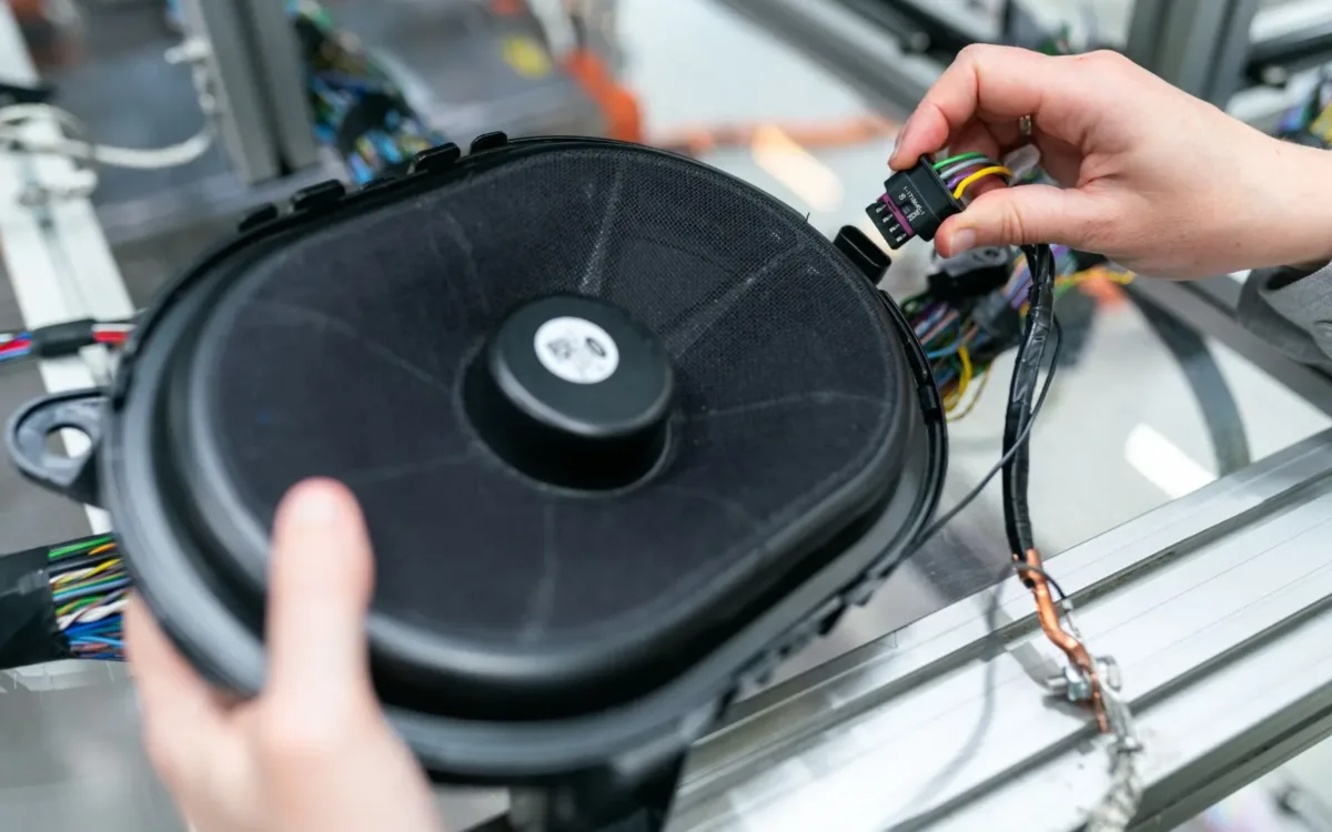 Technician working on a speaker assembly in a workshop