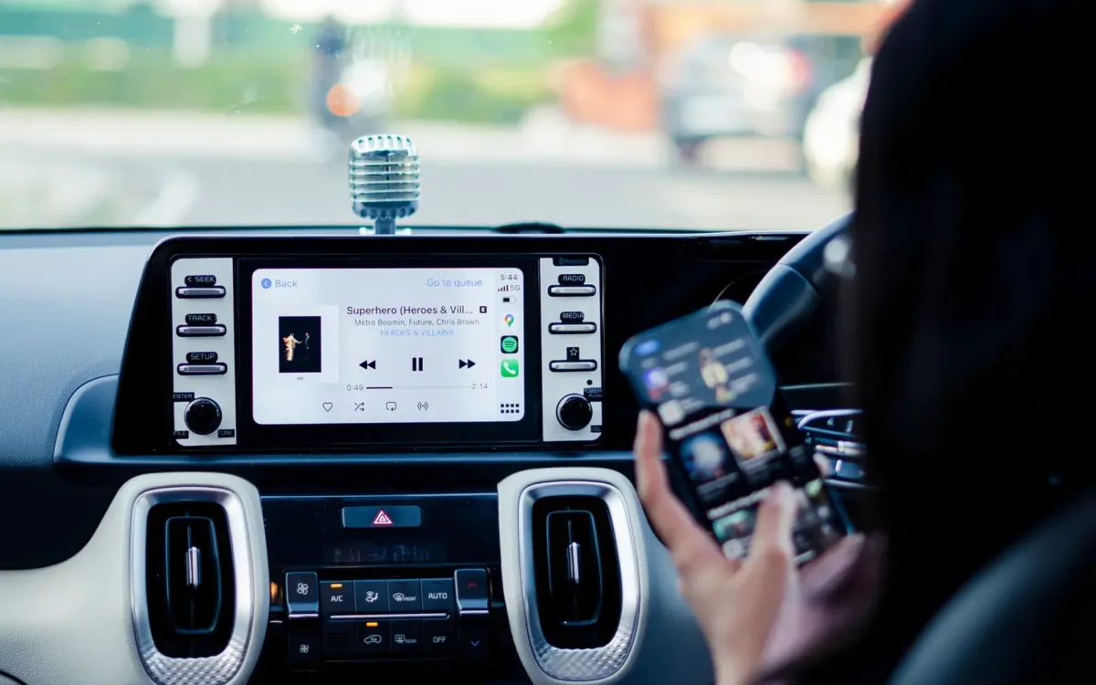 Touchscreen car stereo next to a smartphone, showing how to upgrade car stereo features