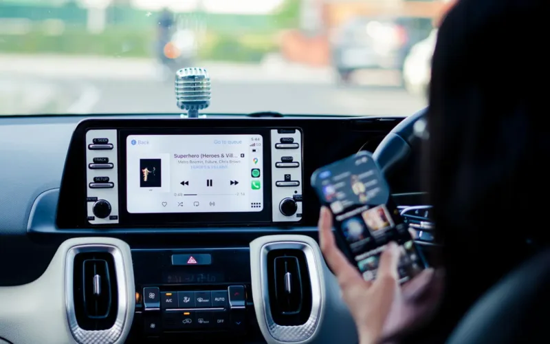 Touchscreen car stereo next to a smartphone, showing how to upgrade car stereo features